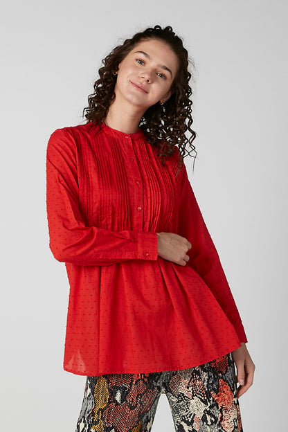 Red long-sleeve blouse with button-front and pintuck texture, relaxed fit