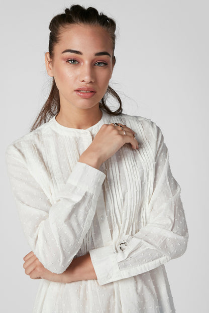 White textured blouse with high neckline and vertical pleat-like stripes