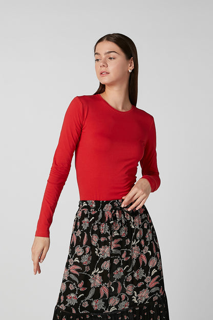 Red long-sleeve top with black floral tiered maxi skirt