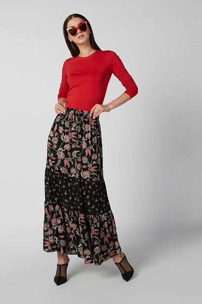 Red long-sleeve top and black floral tiered maxi skirt, full-body view