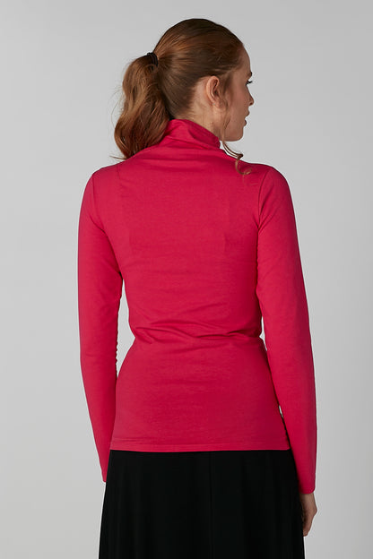 Pink high-neck long-sleeve top, back view with fitted waistband and black skirt.