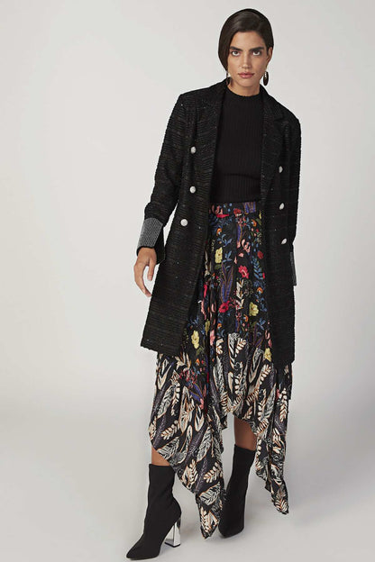 Black ribbed sleeveless turtleneck top under dark textured cardigan