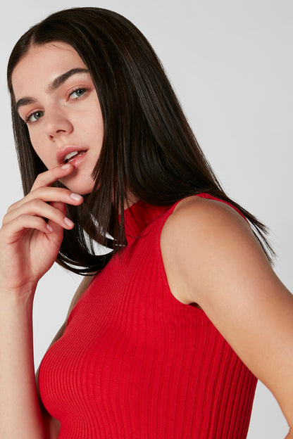 Red ribbed sleeveless knit top with high neckline, side view