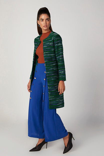 Orange ribbed sleeveless knit top peeking under green textured cardigan