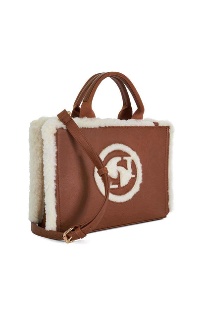 Brown handbag with white shearling trim, top handles, front logo patch and gold hardware