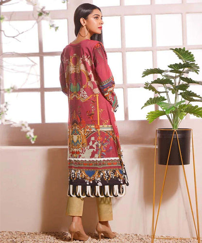 Women's maroon tunic with multicolor back print and tassel-trim hem, shown from side