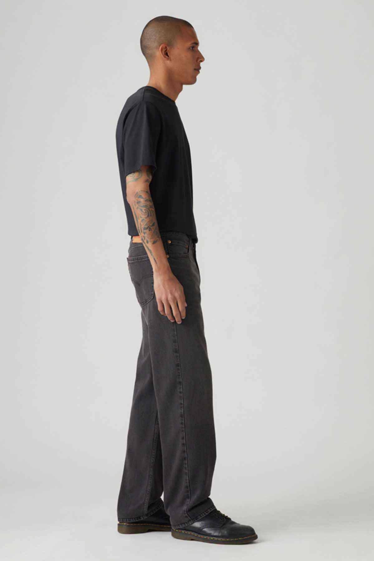 Levi's black denim jeans, side view with relaxed fit and stitched seams