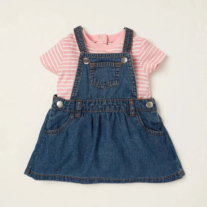 Babyshop denim pinafore over pink striped baby T-shirt with snap buttons