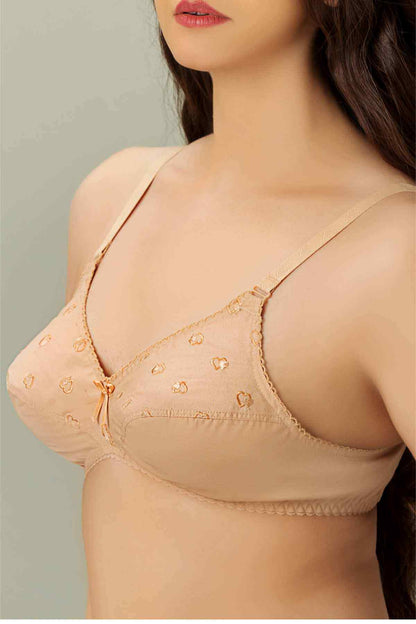 Tan bra with tiny heart print, lace-edged cups, and tie front