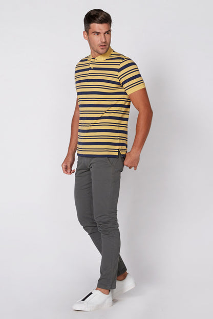 Yellow and navy striped short-sleeve polo shirt worn with gray pants