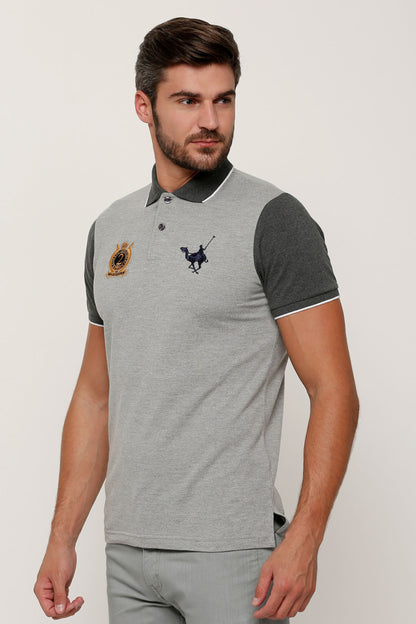 Grey polo shirt with dark sleeves and embroidered crest on chest
