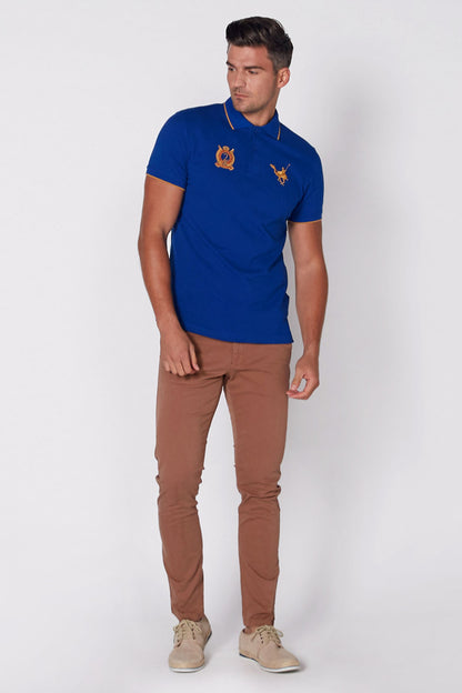 Blue polo shirt with collar, short sleeves, and embroidered crest