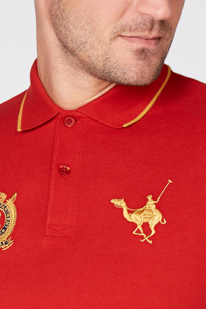 Red polo shirt with gold-trim collar and crest patch, button placket, horse logo