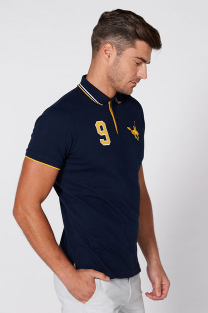 Navy polo shirt with yellow collar trim, number 9 front print, side view