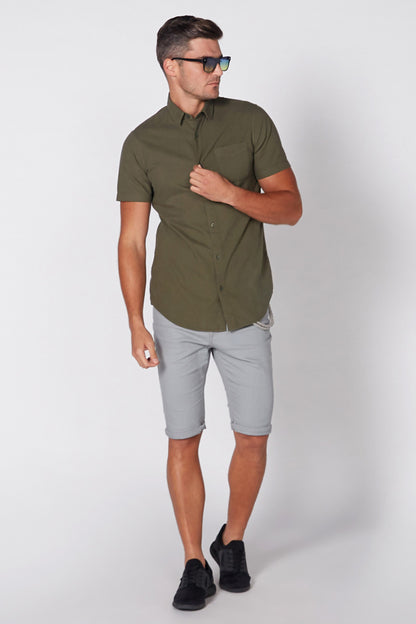 Olive-green short-sleeve button-up shirt, side view showing collar and sleeves