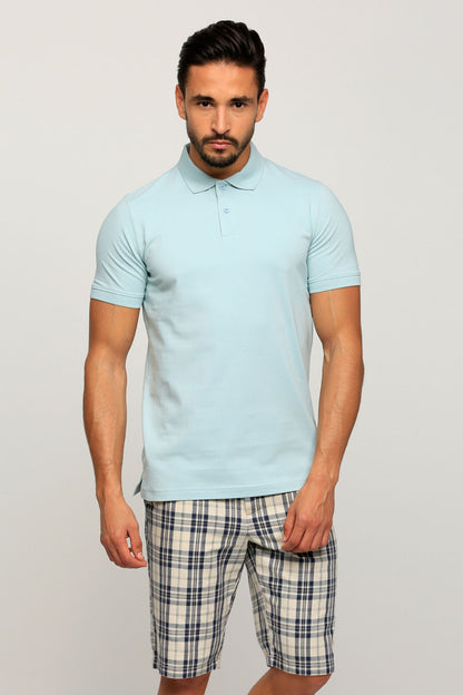 Light blue short-sleeve polo shirt with button placket, worn with plaid shorts