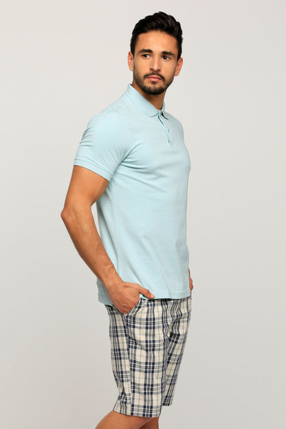 Light blue polo shirt with collar and short sleeves, styled with plaid knee-length shorts