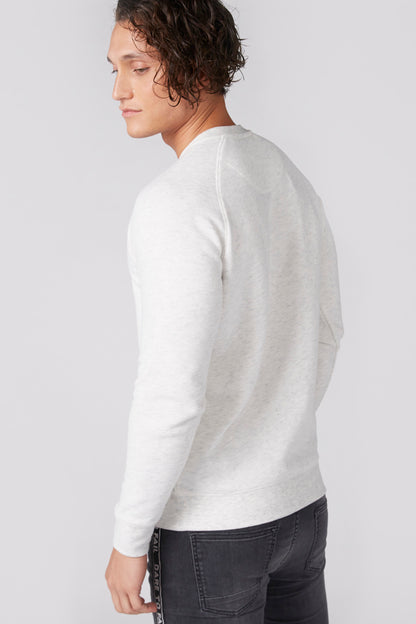 Long-sleeve crewneck shirt in white, side view with hem and sleeve cuff