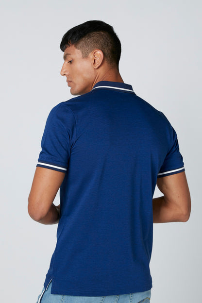 Blue polo shirt with white-trim collar and sleeve cuffs, back view.
