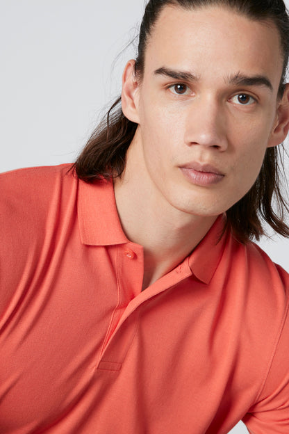 Orange polo shirt close-up, collared neckline with visible buttons