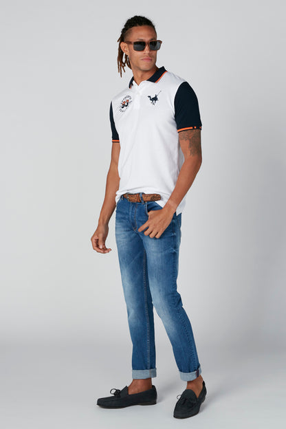 White polo shirt with dark sleeves, chest logo, short sleeves