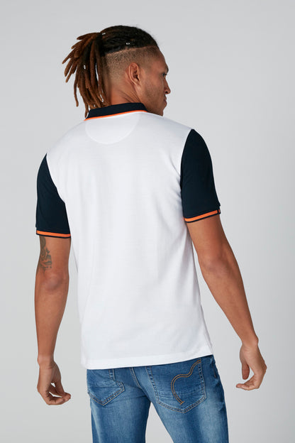 White polo shirt back view with navy sleeves and orange trim at collar