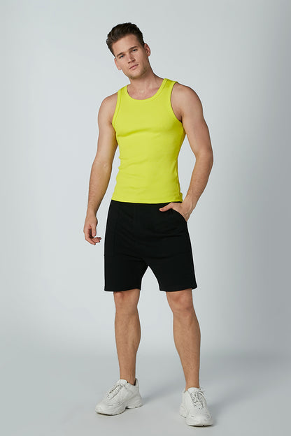Neon green sleeveless tank top with black athletic shorts, full view