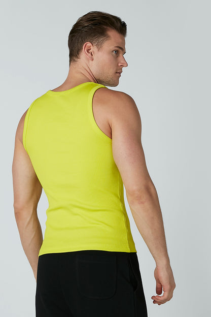 Neon green sleeveless tank top and black athletic shorts, back/side view