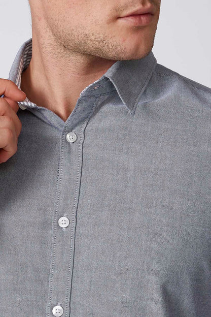 Men's navy-blue button-up shirt close-up of collar and button placket