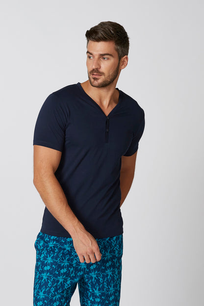 Men's navy short-sleeve henley shirt with blue tropical print shorts, front view