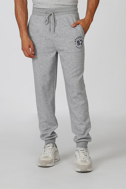 Grey sweatpants with drawstring waist, ribbed cuffs, and 93 logo patch on thigh.