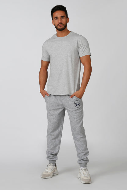 Grey jogger sweatpants with drawstring waist and 93 logo patch on thigh.