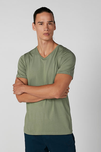 Green short-sleeve T-shirt with V-neck, model front view with arms crossed