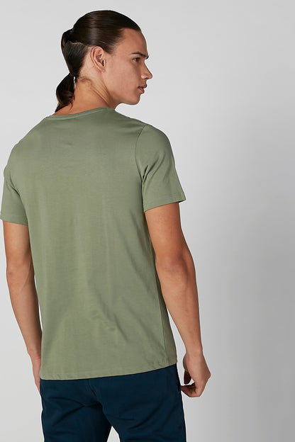 Back view of green short-sleeve T-shirt with straight hem, dark blue pants