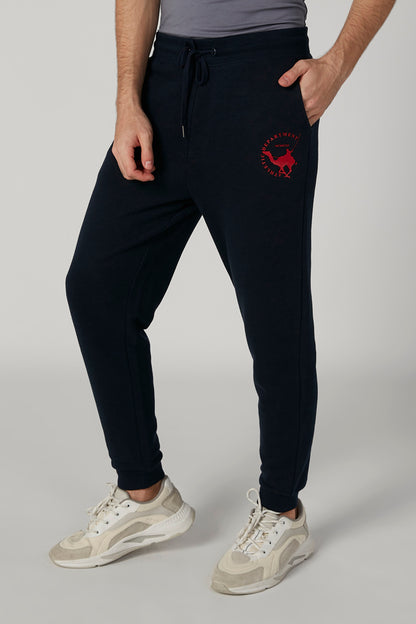 Navy jogger pants with drawstring waist and red graphic on right pocket