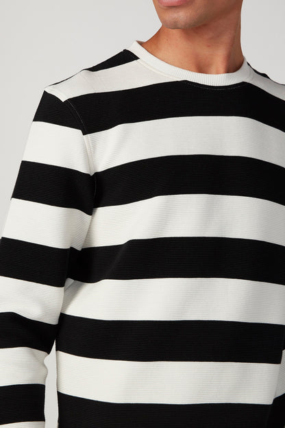 Black-and-white striped crewneck sweater with ribbed neckline, long sleeves