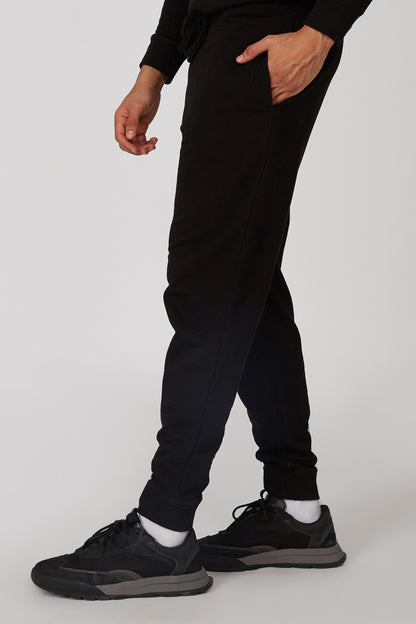 Black tapered jogger pants with elastic ankle cuffs