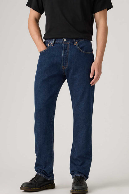 Dark indigo denim jeans, front close-up with button fly and stitched seams