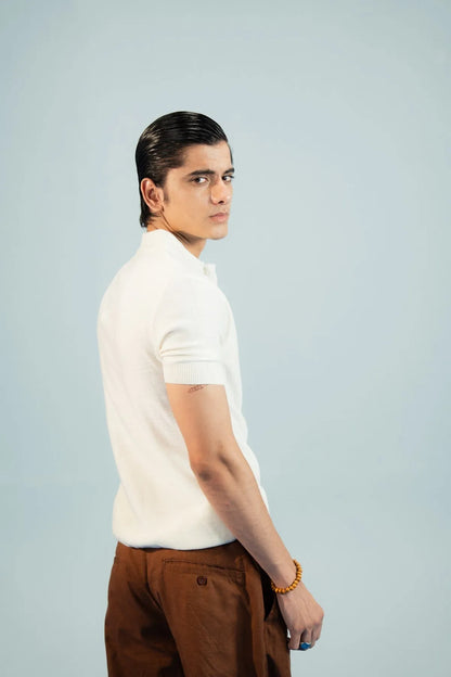 Brackets polo shirt and trousers: white polo with brown trousers, side profile