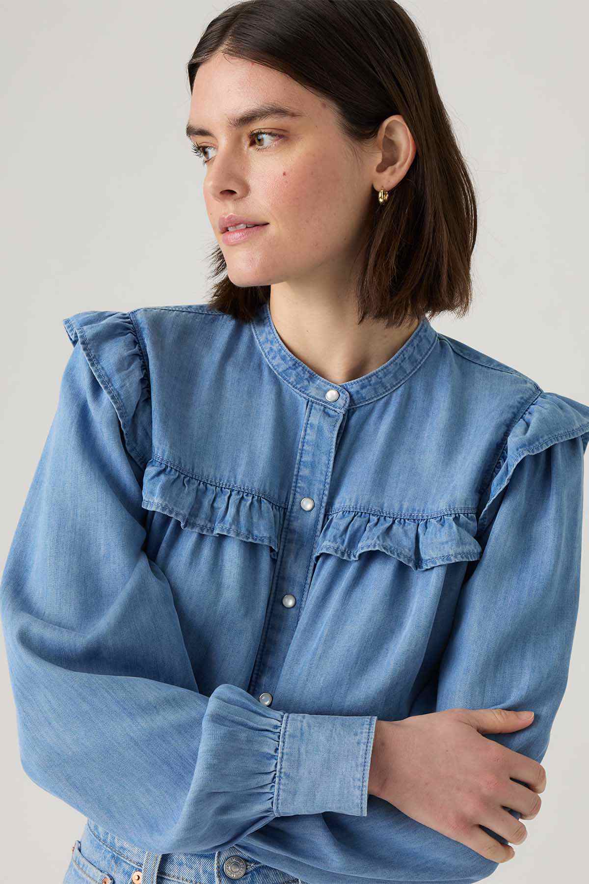 Levi's light blue denim blouse detail: ruffled yoke and buttoned neckline