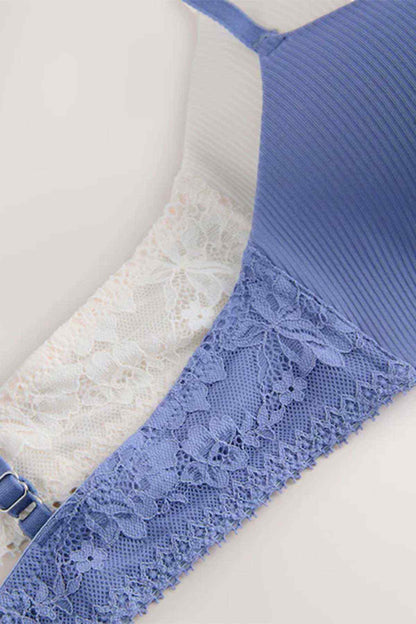 Women's blue bra strap with lace trim and ecru lace lining along edge