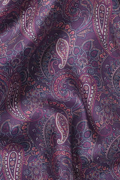 Paisley pocket square fabric close-up, dark purple with pink and blue paisley swirls