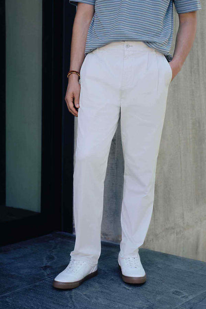 Light beige chino trousers with belt loops and button front