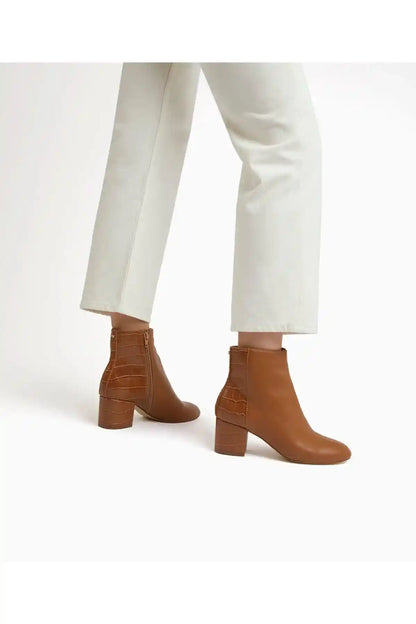 Camel ankle boots with block heel worn with light pants