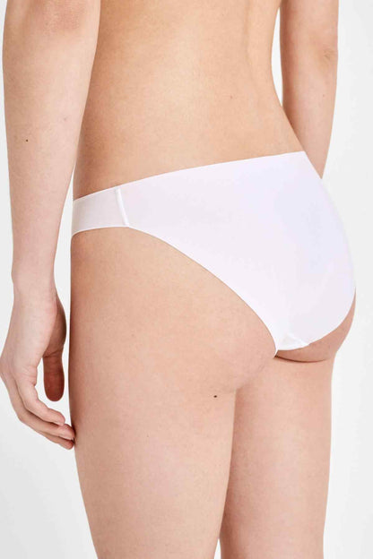 White bikini panties back view on model, smooth coverage and seams