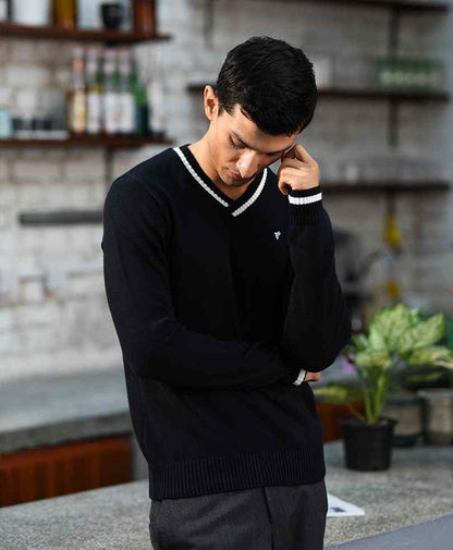 Black fitted V-neck knit sweater with ribbed hem and long sleeves, small chest logo