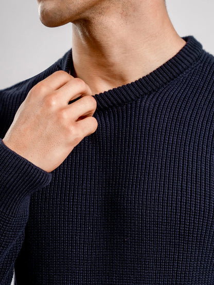 Navy blue knit crewneck sweater neckline and ribbed collar detail
