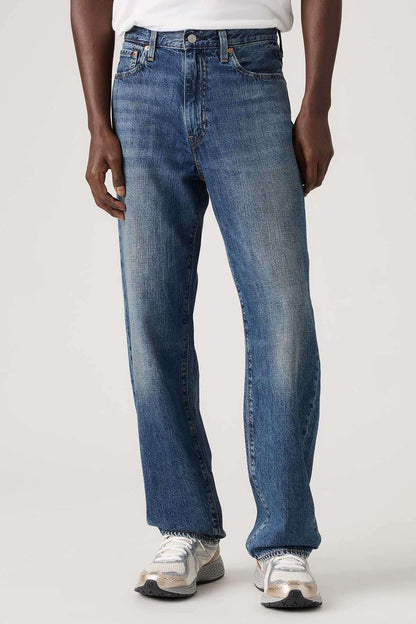 Dark wash denim jeans with button fly, front pockets, and belt loops