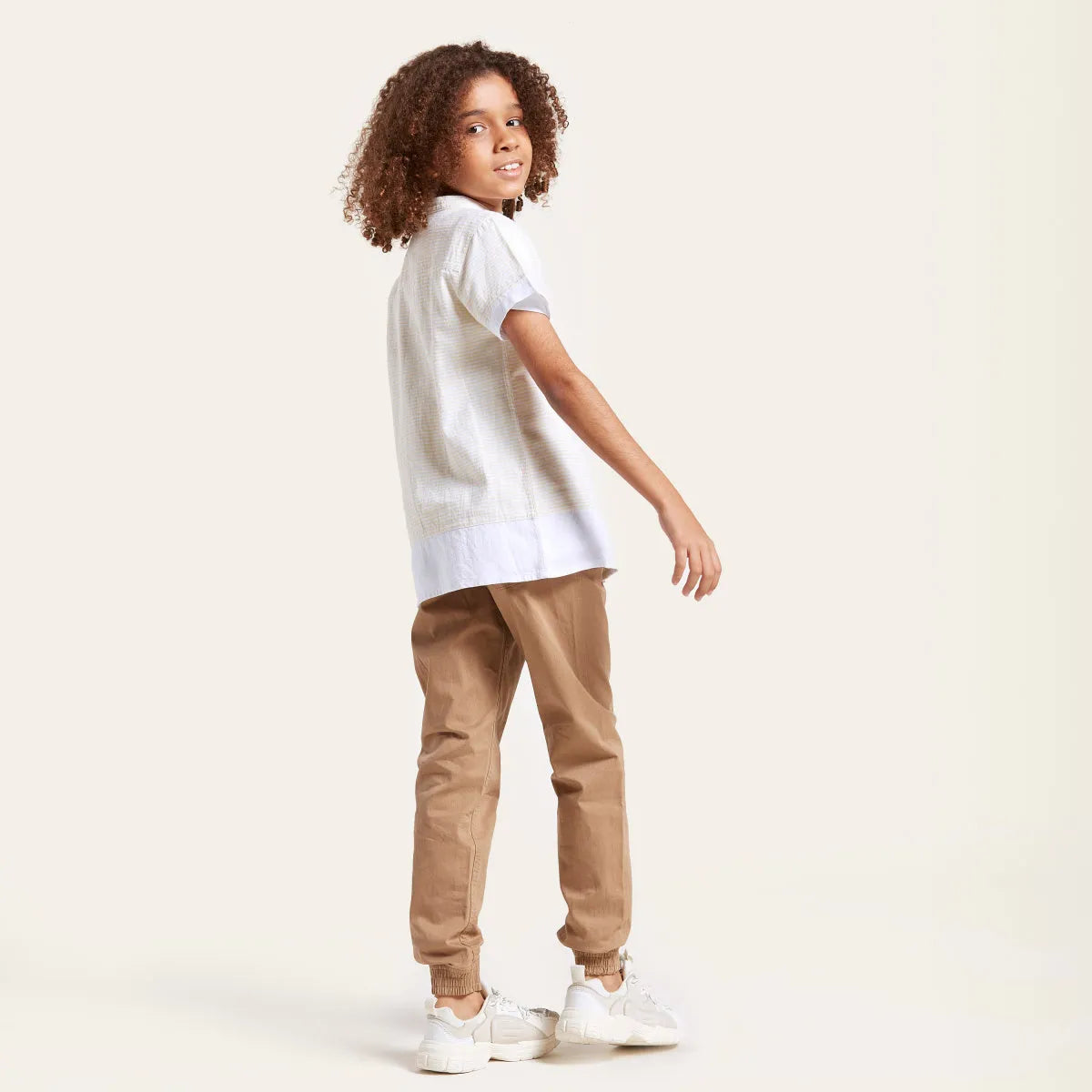 Beige toddler pants with elastic waistband and drawstring, side view