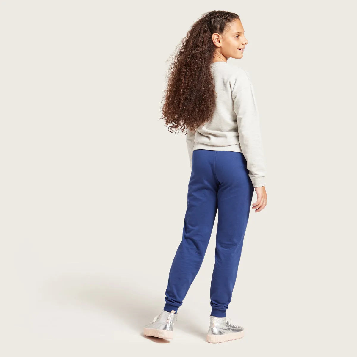 Kids blue jogger pants with elastic waistband, drawstring, and cuffed ankle hems